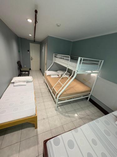 a room with two bunk beds and a chair at Ciello Accomodation in Cagayan de Oro