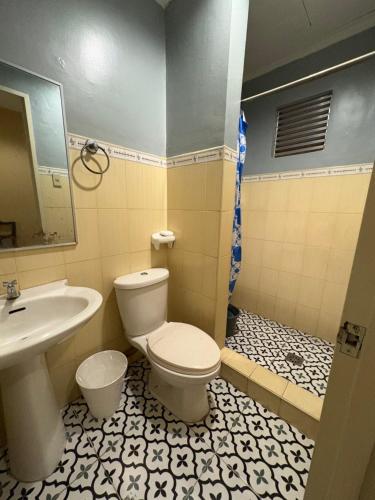 a bathroom with a toilet and a sink at Ciello Accomodation in Cagayan de Oro