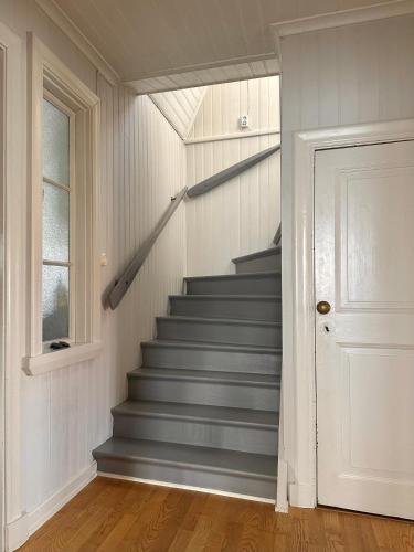 a staircase in a home with a white door at Archipelago villa with seaview and 2min to baths in Asperö