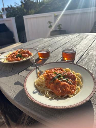 a plate of pasta with meat on a table at Archipelago villa with seaview and 2min to baths in Asperö