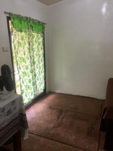 a room with a window with a green curtain at Sobral Rice Terraces View in Antihon