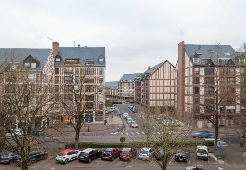 a city with cars parked in a parking lot at B&B HOTEL Troyes Centre in Troyes