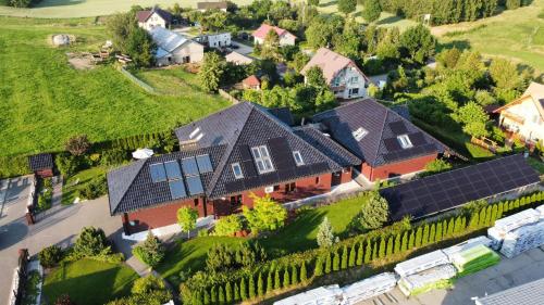 an aerial view of a house with solar panels at Premium Residence SPA & Garden in Glińcz