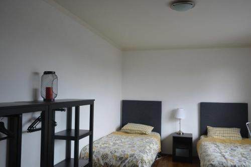 a room with two beds and a table in it at Nice 3 Bedroom Serviced apartment in Oosterbeek