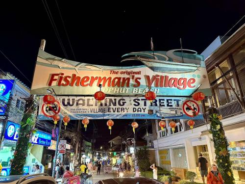 a sign for a festival on a street at night at Bophut Fisherman's Village Blue Ocean Villa in Bophut