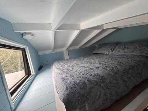 a bedroom with a bed and a window in it at Bon yr Llew, Coity Bach in Brecon