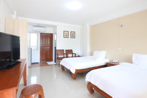 Cama o camas de una habitación en Poonnagunn hotel