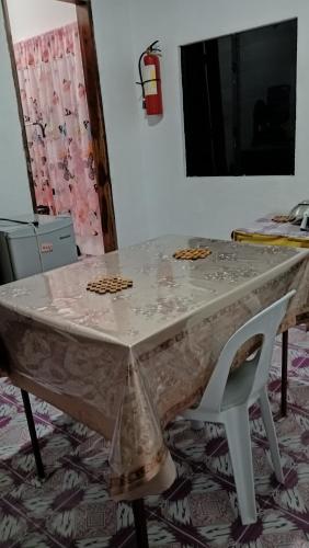 a table and a chair with a table and a mirror at RM Homestay in Siquijor