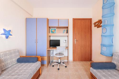 a room with two beds and a desk with a television at F & B Summer Collection - Kassandra - Siviri in Siviri