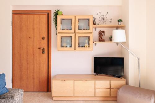 a living room with a tv and a wooden door at F & B Summer Collection - Kassandra - Siviri in Siviri