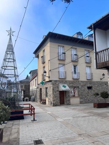 a building with a christmas tree in front of it at Casa la Plaza in Molinaseca