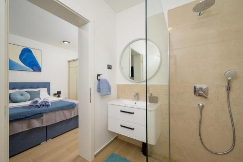 a bathroom with a shower and a bed and a sink at Villa Brajde by IstriaLux in Gajana