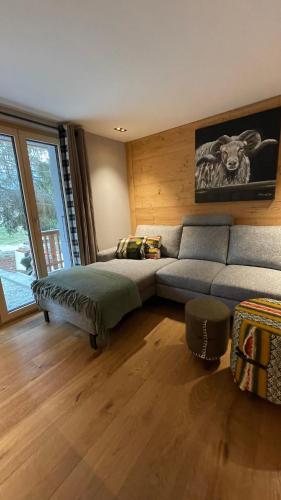 a living room with a couch and a bed at Chalet Myriam in Grächen