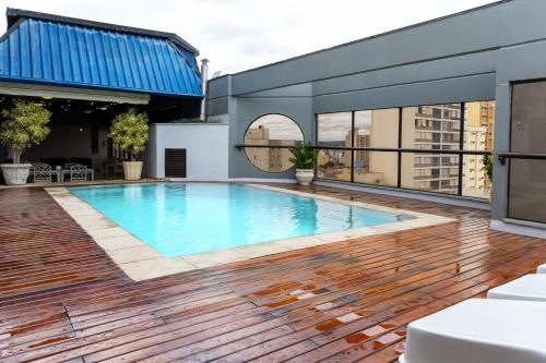 a swimming pool on the roof of a building at Park Tower Campinas Residence by Nacional Inn in Campinas