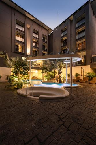 a large building with a table in front of it at Stay Collection Nimman Chiangmai in Chiang Mai
