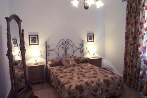 a bedroom with a bed and two night stands and two lamps at Casa Víctor in Priego de Córdoba