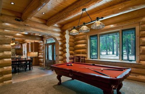 a pool table in a room with wooden walls at El Capitan in Wawona