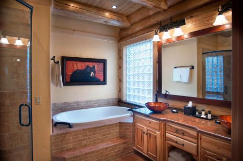 a bathroom with a tub and a large mirror at El Capitan in Wawona