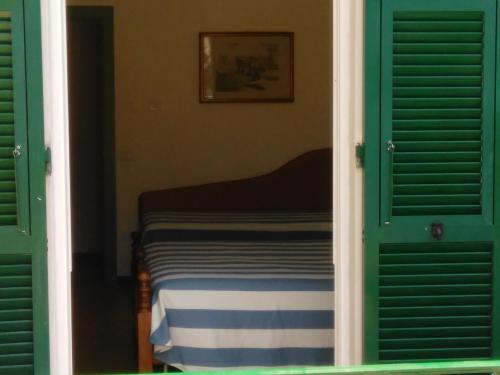 a bedroom with green doors and a bed in a room at Ristorante Hotel Mira in Sestri Levante