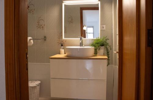 a bathroom with a sink and a mirror at VV Saso Beach Puerto Naos in Puerto Naos