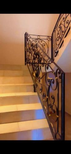 a stairway with a metal railing next to some stairs at NÉFERTITi in Yaoundé