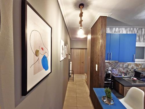 a kitchen with blue cabinets and a blue counter top at GpxClrTheStreetFashionSuiteNW in Larisa
