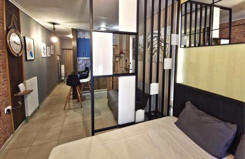 a bedroom with a large bed and a hallway at GpxClrTheStreetFashionSuiteNW in Larisa