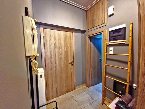 a room with a door and a room with a fan at GpxClrTheStreetFashionSuiteNW in Larisa