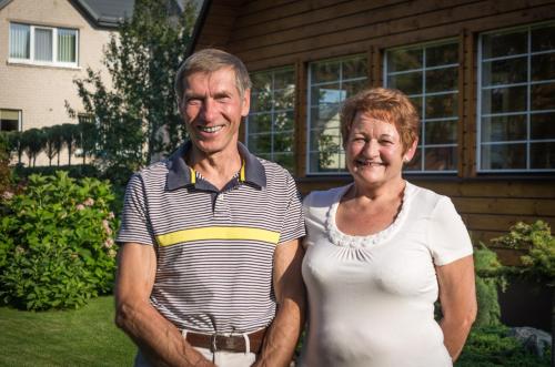 a man and a woman standing in front of a house at Zofija in Birštonas