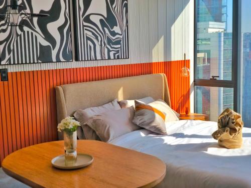 a bedroom with a bed with a wooden table at Republica del Salvador Coliving Ecuador XOE in Quito