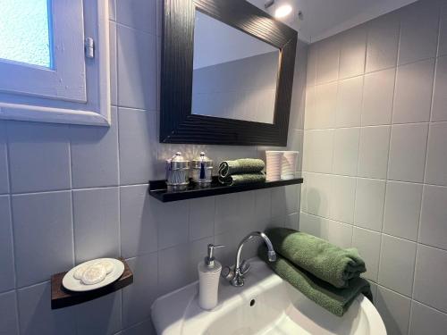 a bathroom with a tub and a mirror and a sink at Les Hortensias in Espoey