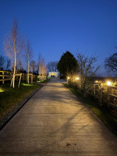 an empty road at night with lights on at Eastington in Lapford