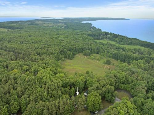 an aerial view of a field with trees and water at Hidden Haven in Traverse City