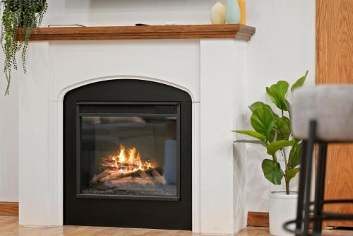 a fireplace with a fire inside of it at Hidden Haven in Traverse City