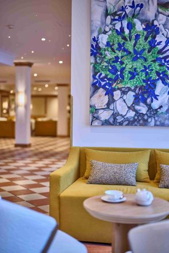 a living room with a couch and a table at The Glacier Hotel - ex Eurotel Victoria - in Les Diablerets