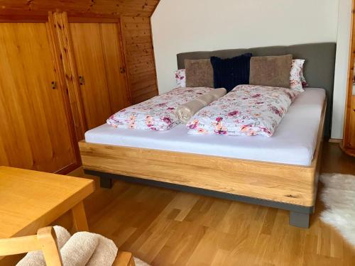 a bedroom with a bed with flowers on it at Ferienhaus Freiraum in Niederwölz