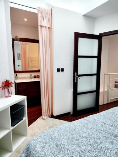 a bedroom with a door leading to a bathroom at Maison centre ville proche plage Wifi in Concarneau