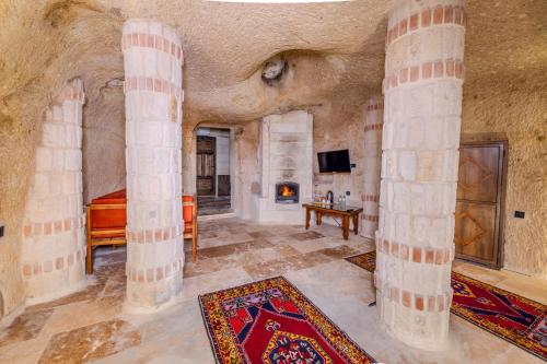 a large room with columns and a tv in a building at Angel View Suites in Goreme