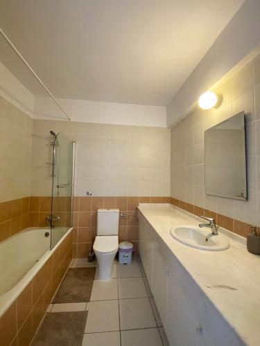 a bathroom with a toilet and a sink and a bath tub at STAY Anthea Gardens - Calm Living in Paphos
