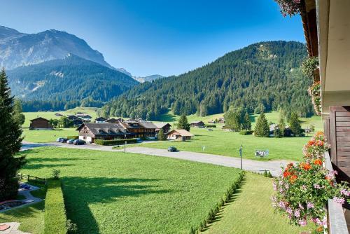 a view of a green field with mountains in the background at The Glacier Hotel - ex Eurotel Victoria - in Les Diablerets