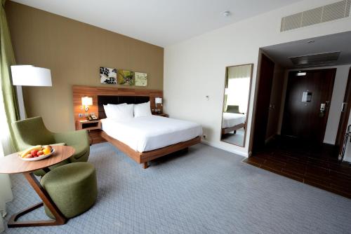 a hotel room with a bed and a table and chairs at Hilton Garden Inn Sunderland in Sunderland