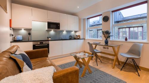 a living room with a couch and a table at Barbican Serviced Apartments by LovelyStay in London