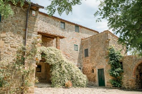 an old stone building with ivy growing on it at Villa Il Poggio in Greve in Chianti