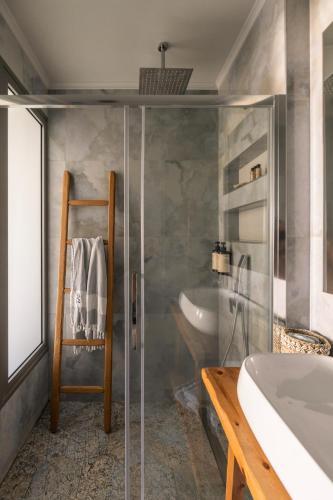 a bathroom with a shower and a tub and a sink at Blue Carpet Luxury Suites in Pefkohori