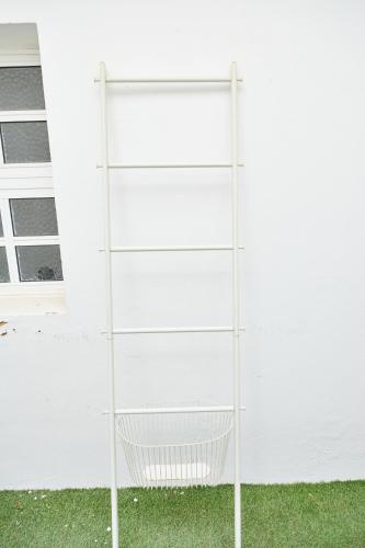 a white shelf in front of a white house at Taah Billa Guest House in Tavira