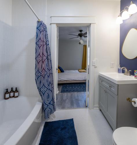 a bathroom with a bath tub and a sink at Bluff City Luxe in Memphis