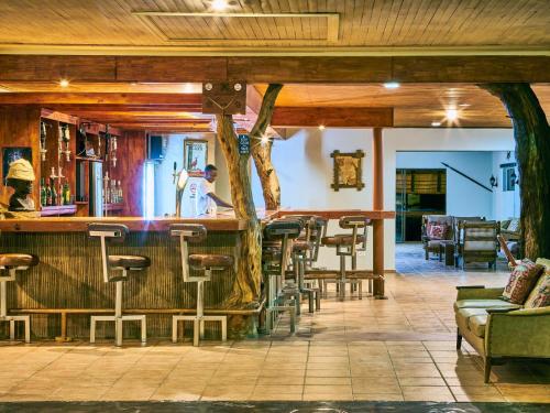 a bar at a restaurant with stools at Hammerstein Lodge in Hammerstein