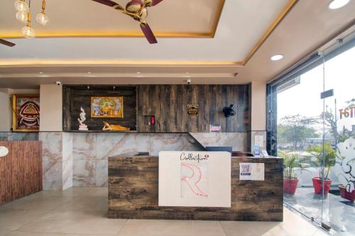 a restaurant with a counter with a sign on it at Hotel O Rasuj in Jaipur