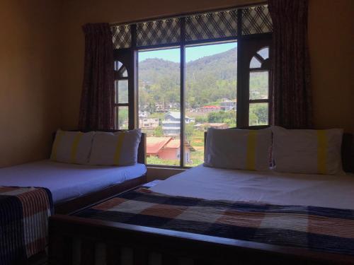 Ένα ή περισσότερα κρεβάτια σε δωμάτιο στο Aurora Residence Nuwara Eliya