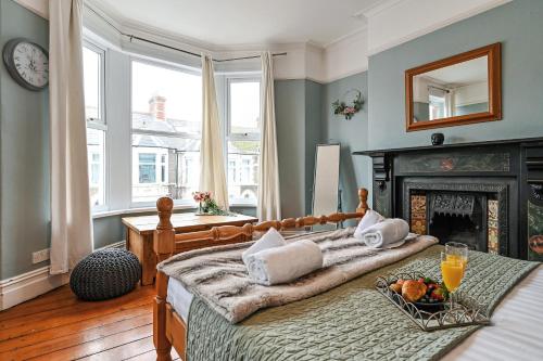 a bedroom with two beds and a fireplace at Beautiful Townhouse, great location - Pet Friendly in Cardiff